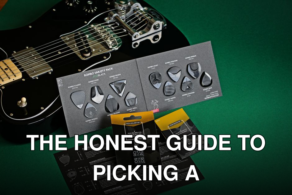 Black electric guitar with variety of guitar picks on a green background.