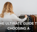Back view of a woman browsing clothes on a rack in a boutique store.