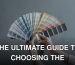 Hands holding a colorful fan of swatches on a gray backdrop, ideal for design themes.