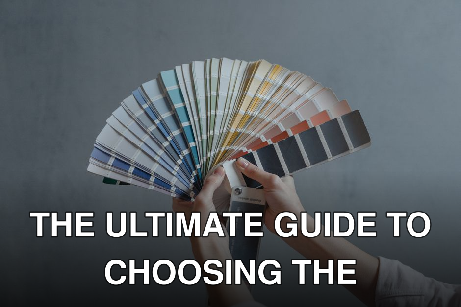 Hands holding a colorful fan of swatches on a gray backdrop, ideal for design themes.
