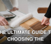 Hands selecting and comparing textile and wood samples for interior design.