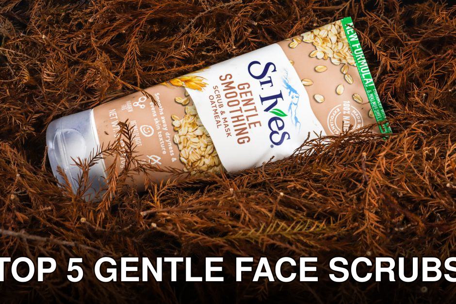 Close-up of a St Ives Gentle Smoothing Scrub tube surrounded by foliage.